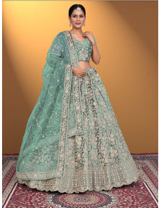 Woman wearing a traditional Pista embroidered lehenga