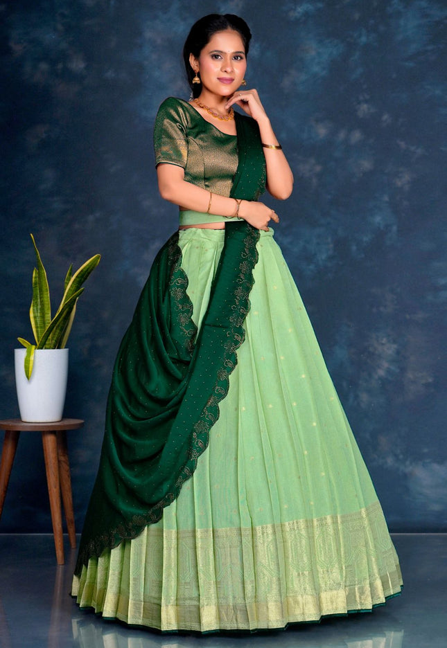 Woman wearing a green and light green traditional lehenga choli with dupatta