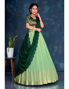 Woman wearing a green and light green traditional lehenga choli with dupatta