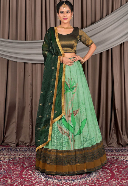 Woman wearing a green traditional lehenga choli with dupatta