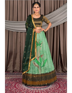 Woman wearing a green traditional lehenga choli with dupatta