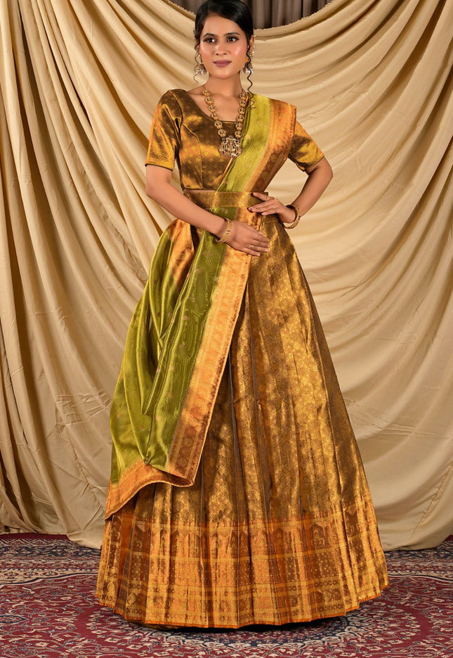 Woman wearing a traditional gold and green lehenga choli
