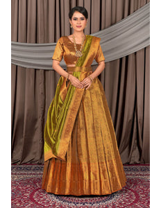 Woman wearing a traditional gold lehenga choli with dupatta