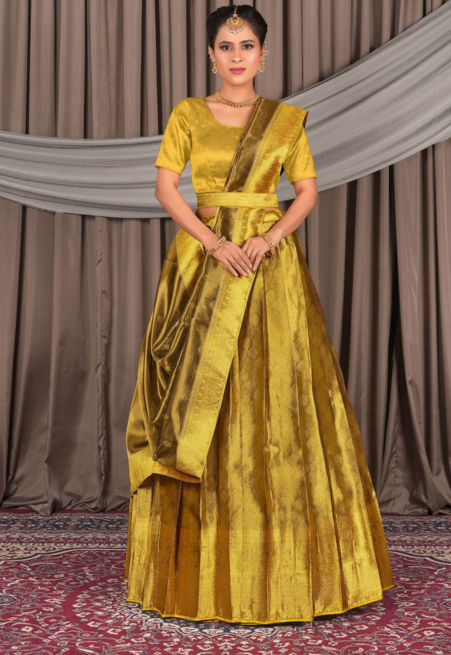 Woman wearing a yellow traditional outfit with a lehenga choli with dupatta