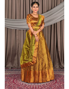Woman wearing a traditional gold and green lehenga choli with dupatta