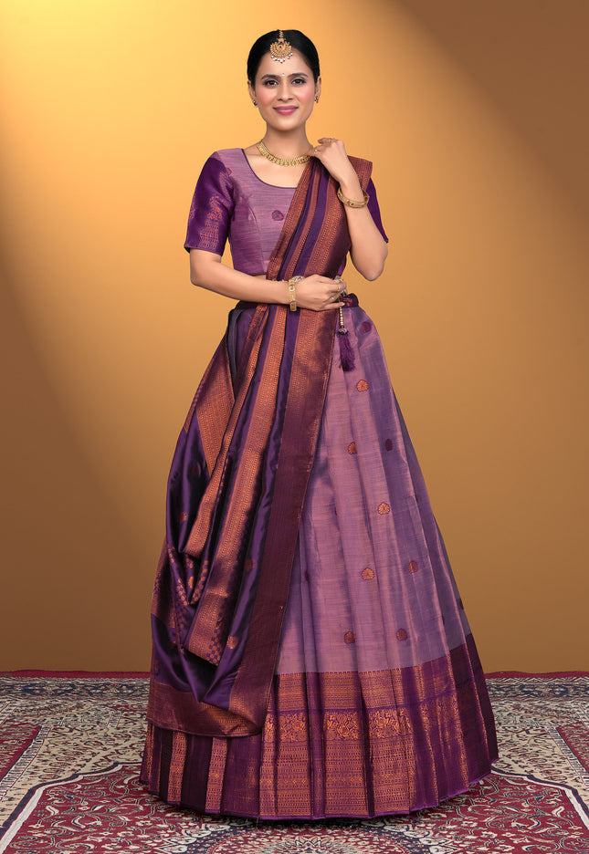 Woman wearing a traditional purple and brown lehenga choli