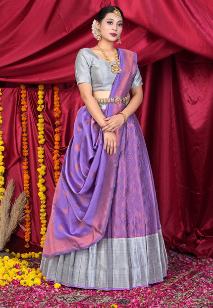 Woman in a traditional outfit with a purple lehenga and silver blouse