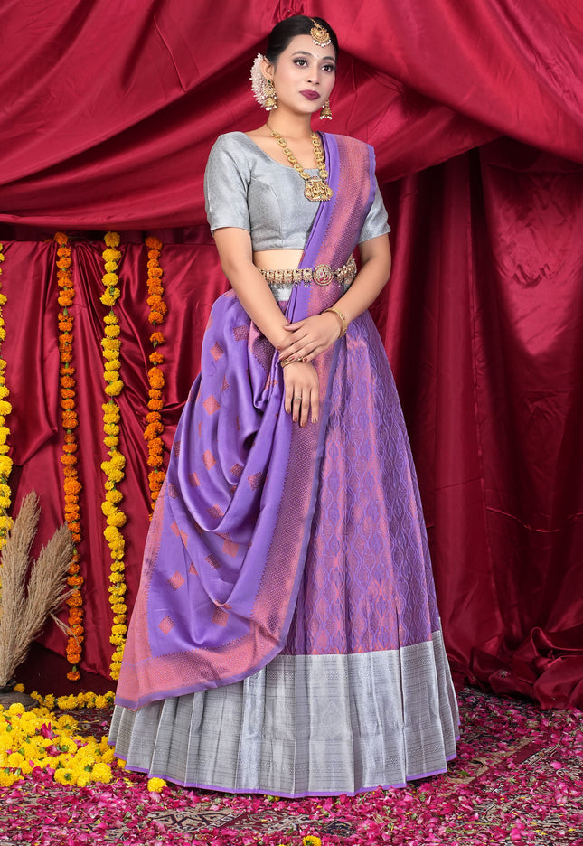 Woman in a traditional outfit with a purple lehenga and silver blouse