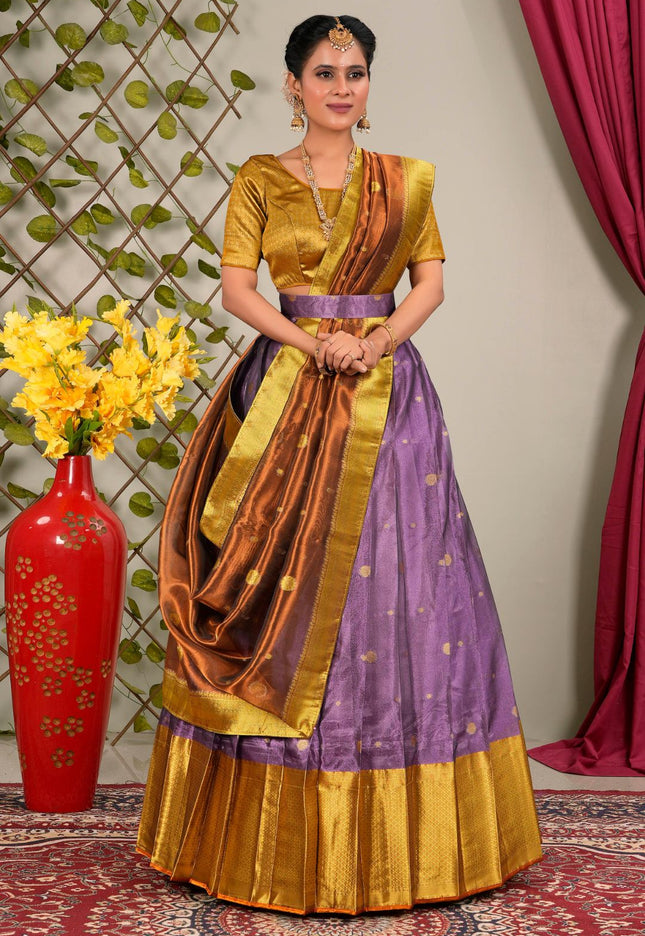Woman wearing a traditional lehenga choli with a gold and purple pattern