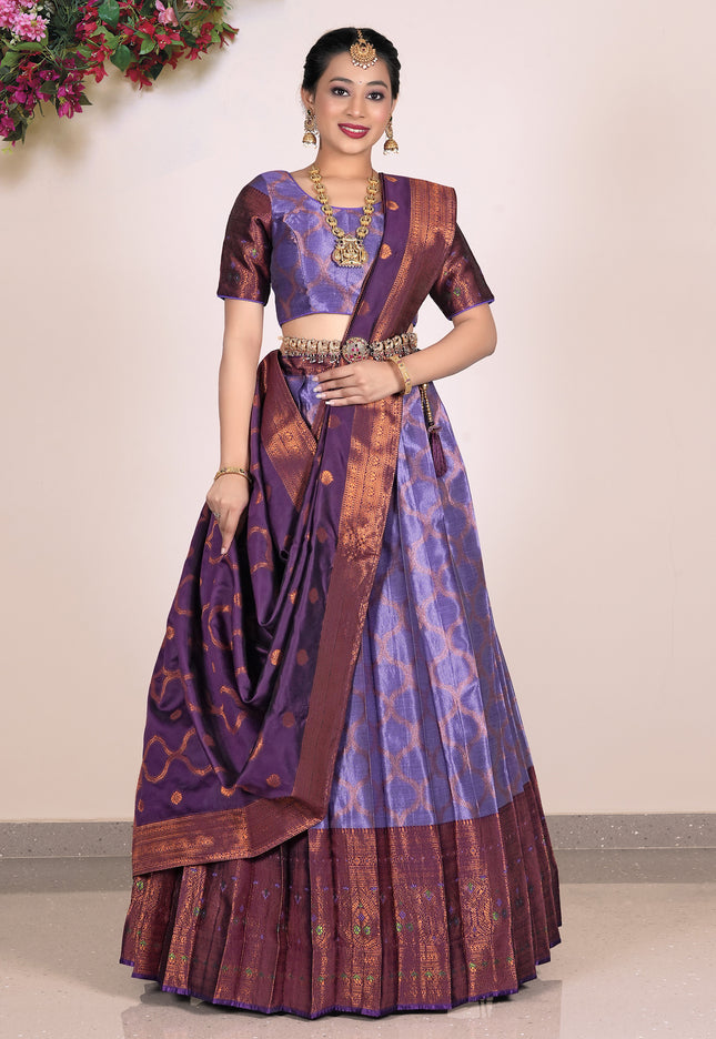 Woman wearing a traditional purple and brown lehenga with blouse