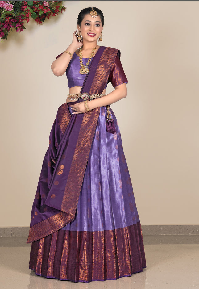 Woman wearing a traditional purple and brown lehenga with a matching blouse