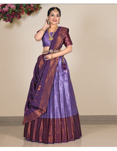 Woman wearing a traditional purple and brown lehenga with a matching blouse