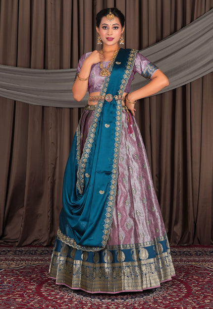 Woman in traditional Indian attire with a blue and pink lehenga choli