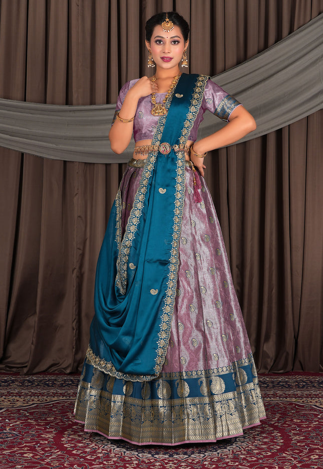 Woman in traditional Indian attire with a blue and pink lehenga choli