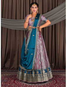 Woman in traditional Indian attire with a blue and pink lehenga choli