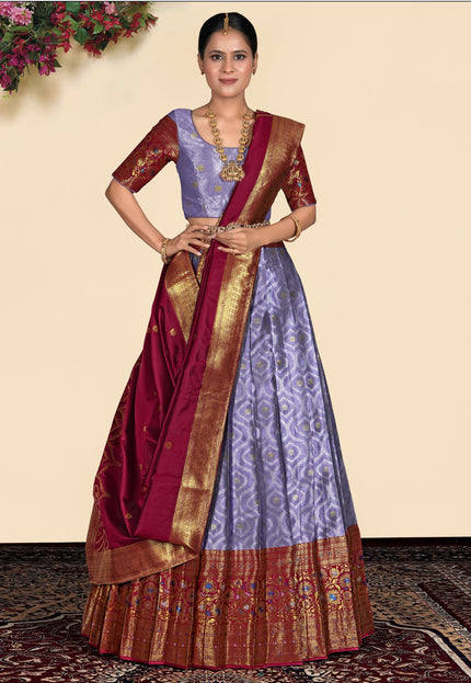 Woman wearing a traditional purple lehenga blouse and maroon dupatta