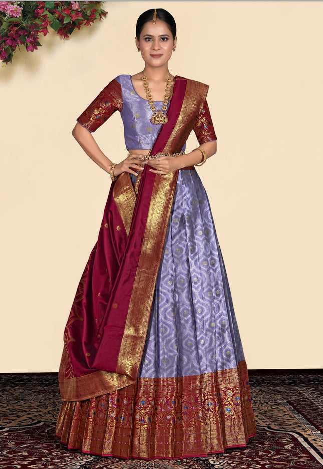 Woman wearing a traditional purple lehenga blouse and maroon dupatta