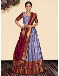 Woman wearing a traditional purple lehenga blouse and maroon dupatta