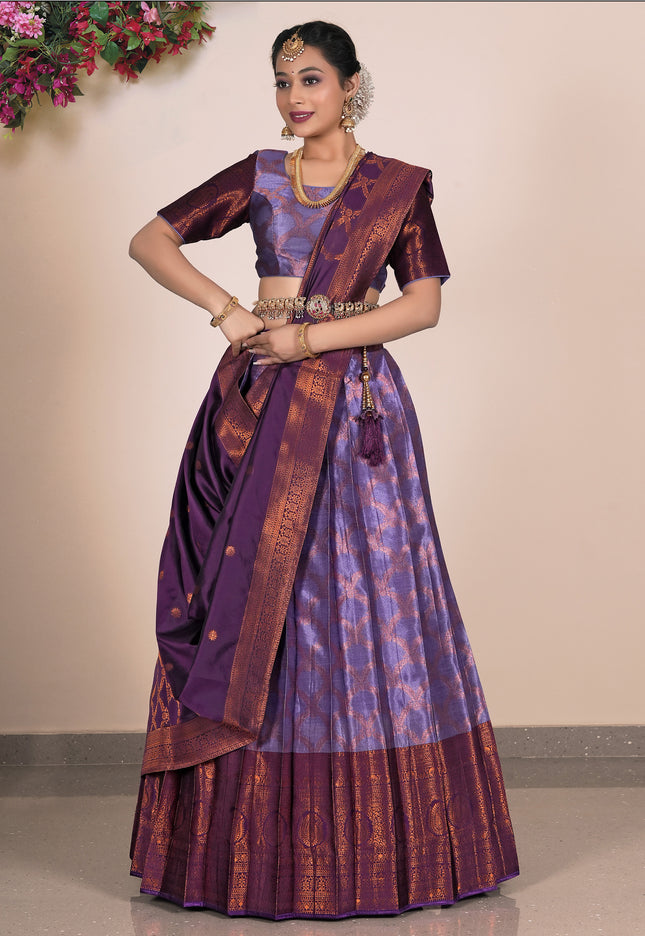 Woman wearing a traditional purple saree with a matching blouse