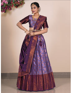 Woman wearing a traditional purple saree with a matching blouse