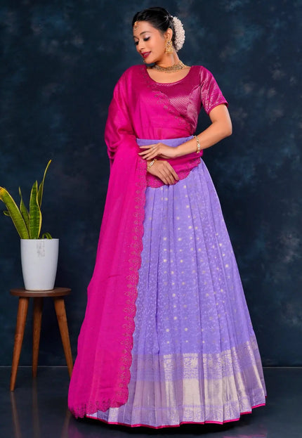 Woman wearing a pink and purple traditional lehenga choli with dupatta