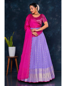 Woman wearing a pink and purple traditional lehenga choli with dupatta