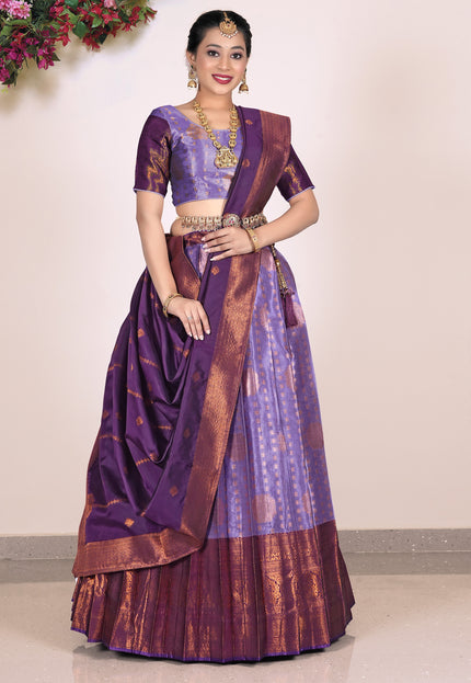 Woman wearing a traditional purple and brown lehenga with blouse