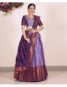 Woman wearing a traditional purple and brown lehenga with blouse