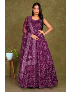 Woman wearing a purple-coloured party wear net gown for women
