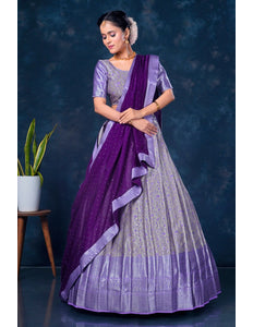 Woman wearing a purple lehenga choli with dupatta