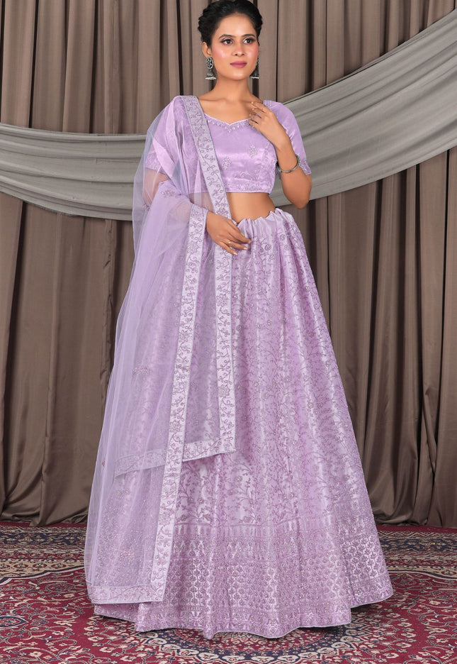 Woman wearing a light purple traditional outfit with a matching dupatta
