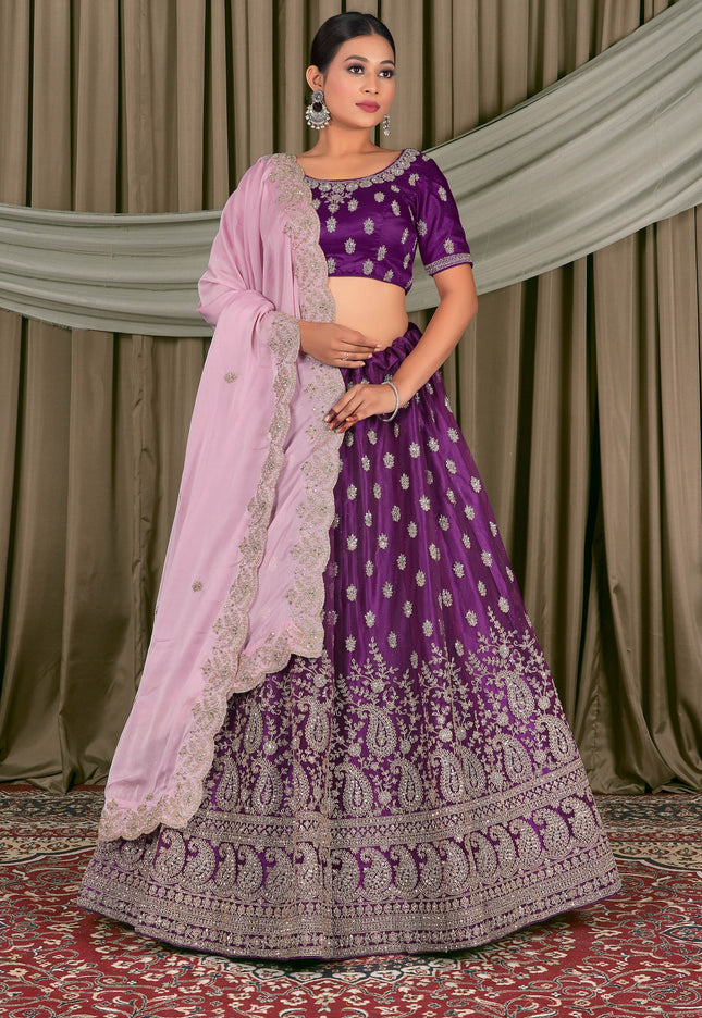 Woman wearing a traditional purple and pink embroidered outfit