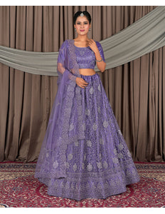 Woman wearing a purple embroidered traditional outfit