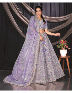 Woman in a traditional lavender outfit with a patterned design