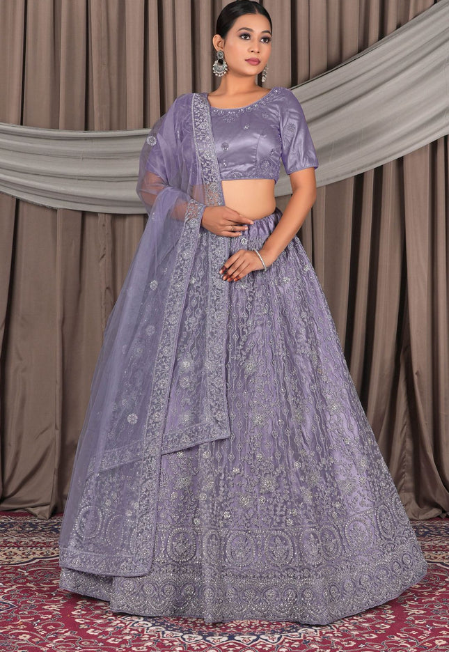 Woman wearing a traditional lavender outfit with a matching dupatta