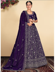 Woman wearing a traditional purple and silver embroidered outfit