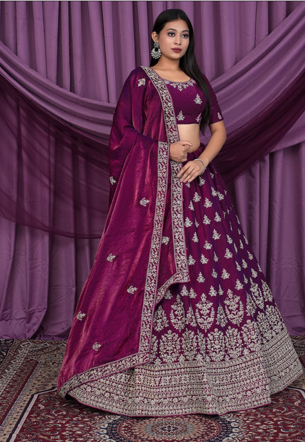 Woman wearing a traditional purple and silver embroidered outfit
