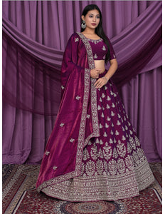 Woman wearing a traditional purple and silver embroidered outfit