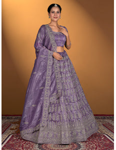 Woman wearing a traditional purple lehenga