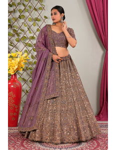 Woman in traditional outfit with purple dupatta