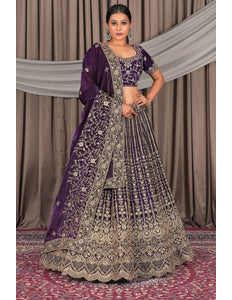 Woman wearing a traditional purple and gold embroidered outfit