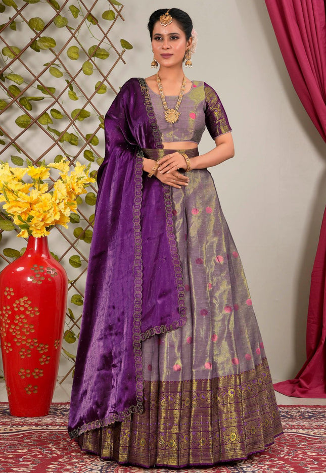 Woman in a traditional outfit with a purple dupatta