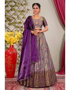 Woman in a traditional outfit with a purple dupatta