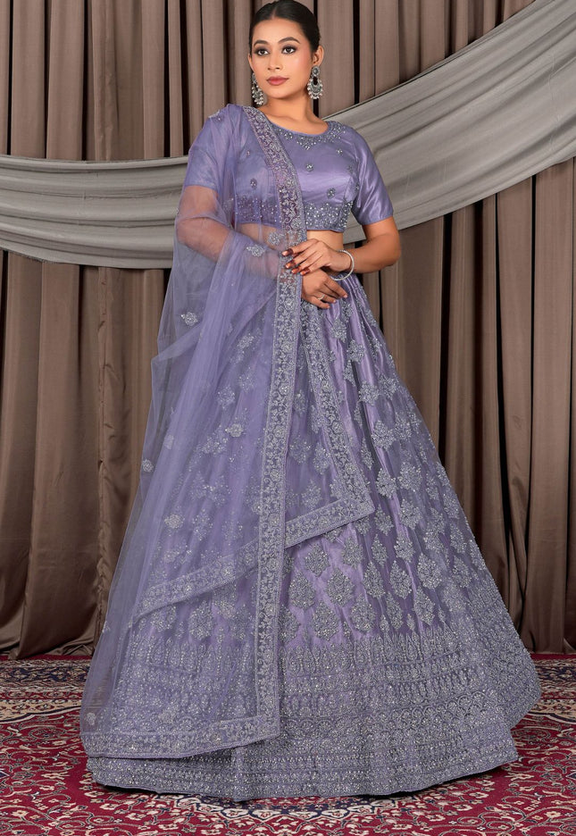 Woman wearing a traditional lavender outfit with intricate patterns