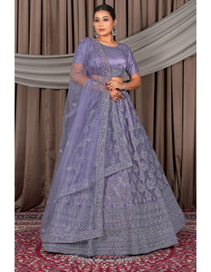 Woman wearing a traditional lavender outfit with intricate patterns