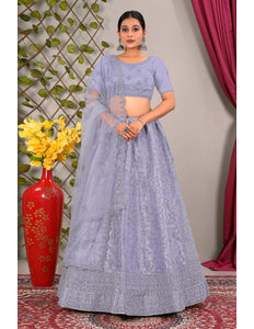 Woman in a light blue traditional lehenga choli with matching dupatta