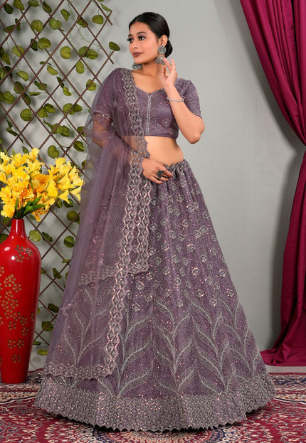 Woman in a purple traditional lehenga choli with matching dupatta