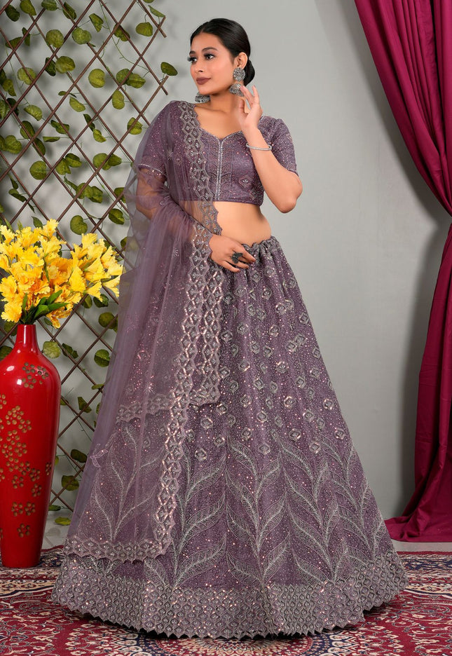 Woman in a purple traditional lehenga choli with matching dupatta