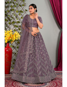 Woman in a purple traditional lehenga choli with matching dupatta