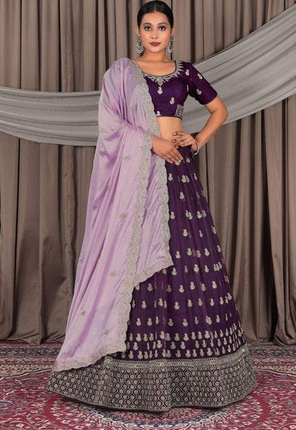 Woman wearing a traditional purple and lavender lehenga with a matching blouse